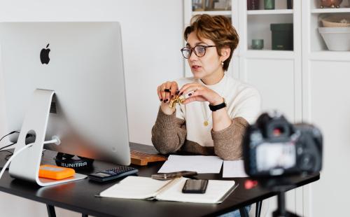 Woman sat at desk in front of a computer