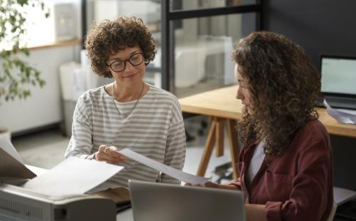 Two women talking at work