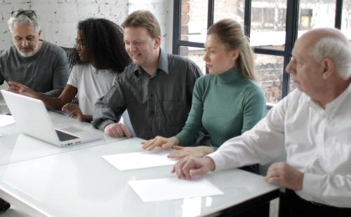 Group of people meeting around a desk