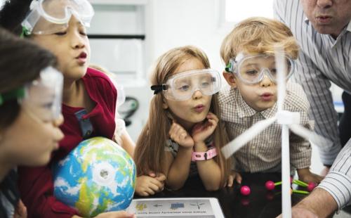 School pupils with a globe and model wind turbine