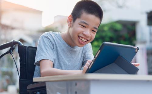 Pupil in a wheelchair using a laptop