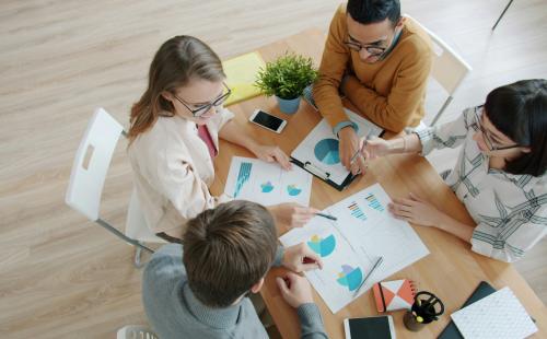 People discussing around a desk
