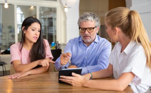 Professionals discussing around a desk