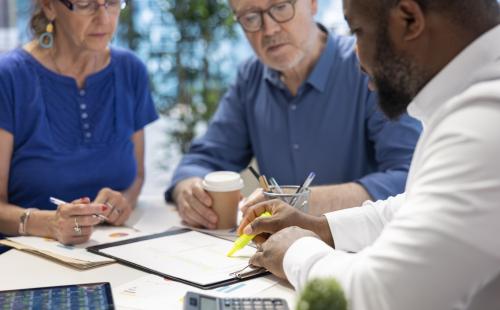Adults discussing a finance report