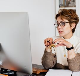 Woman sat at desk in front of a computer