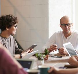 Adults discussing round a table